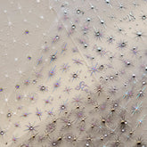 Close-up of gold star nail stickers adorned with sparkling crystals
